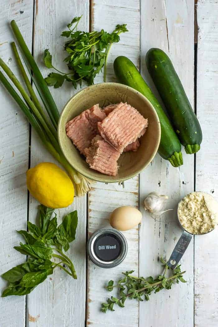 zucchini, lemon, turkey, and other ingredients on a white board.