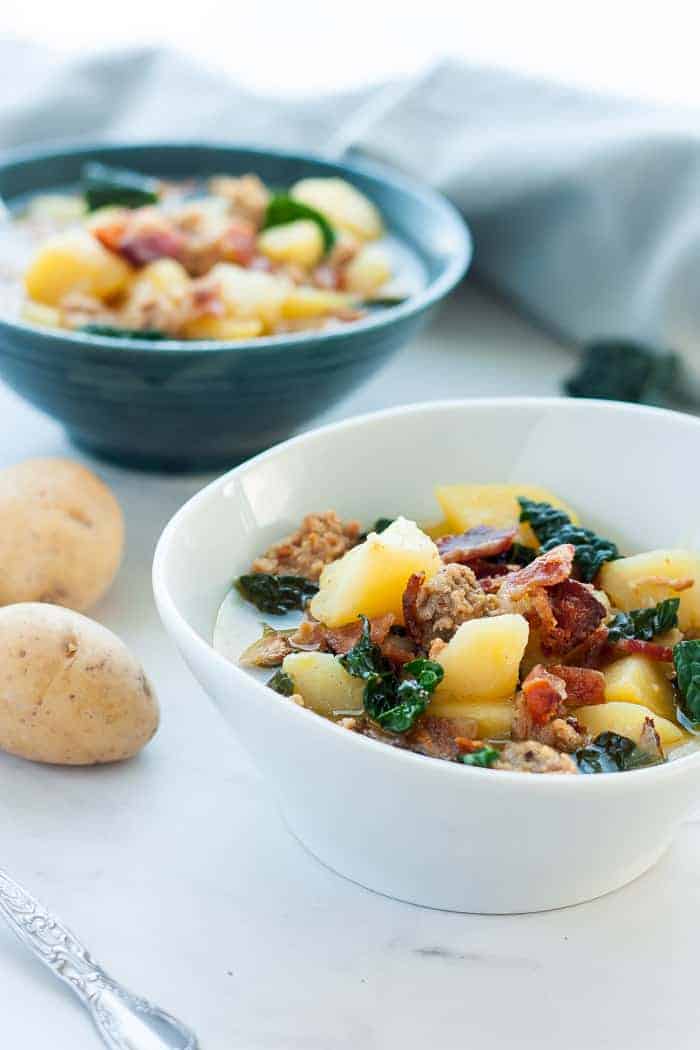 2 bowls of zuppa toscana with potatoes.