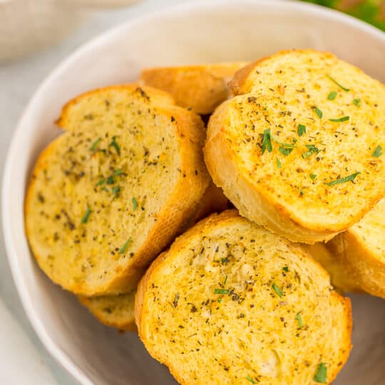 a bowl of air fryer texas toast topped with chopped parsley