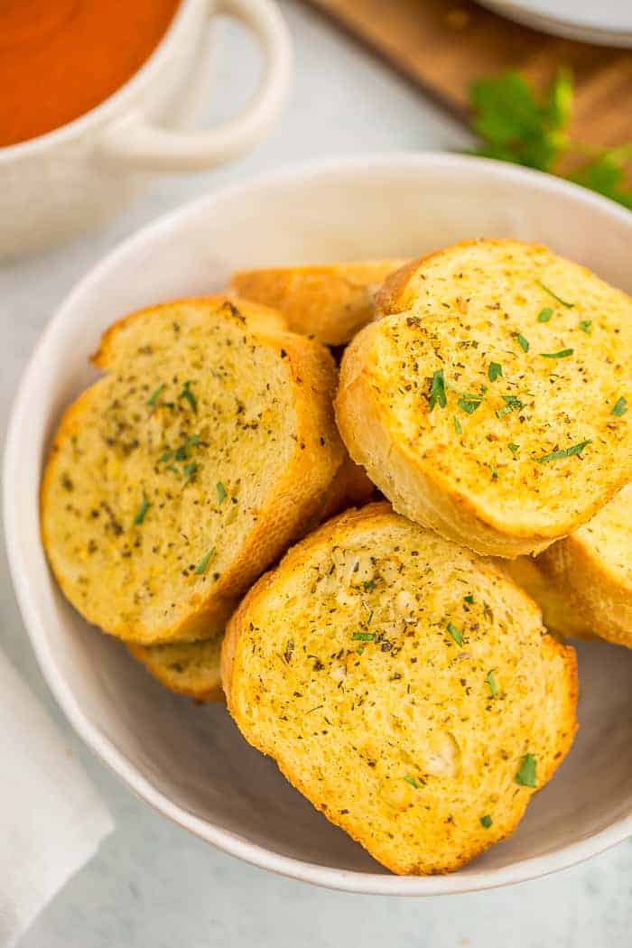 a bowl of air fryer texas toast topped with chopped parsley