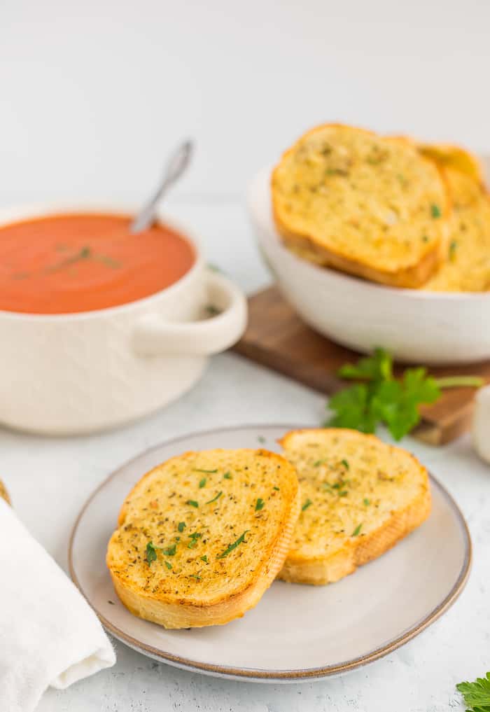 texas toast made in an air fryer on a plate with tomato soup