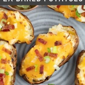 a plate of air fryer twice baked potatoes topped with cheese, chopped bacon, and green onions