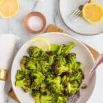 roasted broccoli in a bowl with a fork