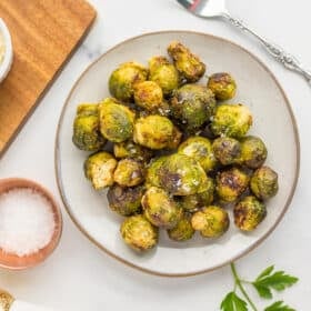 Air fryer frozen brussel sprouts on a grey plate