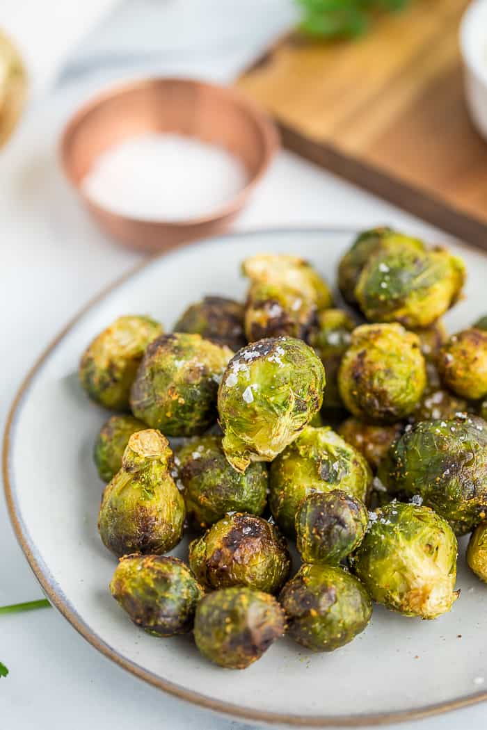 a pile of baby brussel sprouts on a grey plate