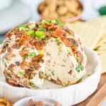 a side profile of a jalapeno popper cheeseball with a slice removed