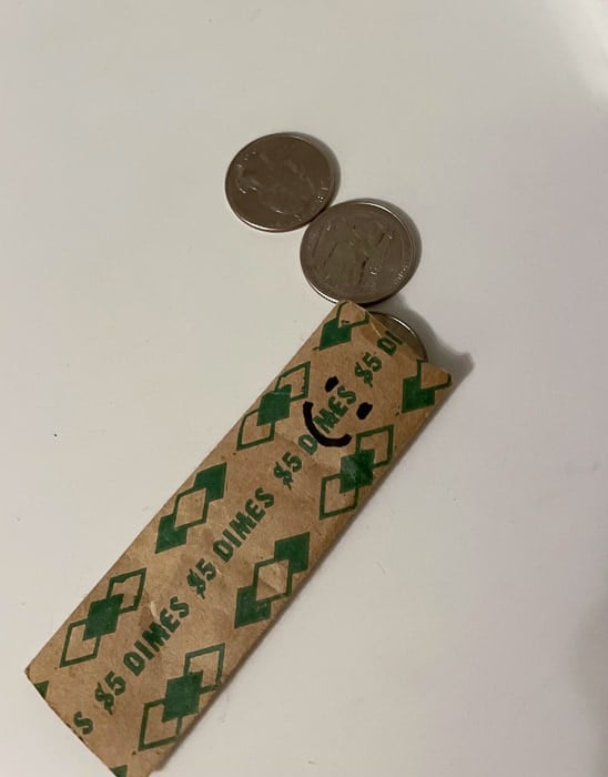 a paper money roll with a smile drawn on it