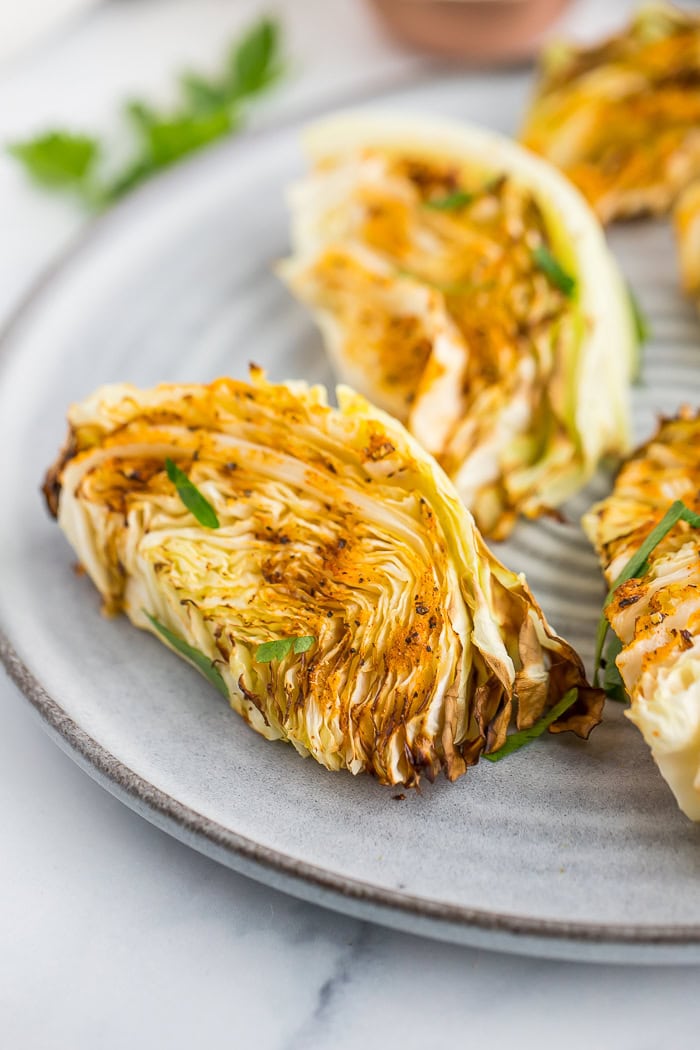 grilled air fryer cabbage wedges on a plate.