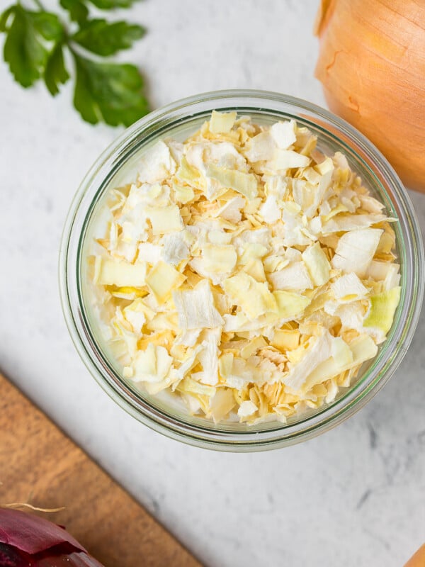 an up-close image of dehydrated onions in a glass bowl