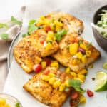 a plate of grilled air fryer mahi mahi topped with mango pico de gallo.