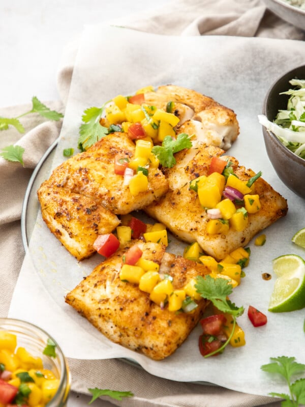 a plate of grilled air fryer mahi mahi topped with mango pico de gallo.