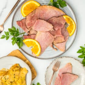 a plate of Instant Pot ham with oranges and parsley.