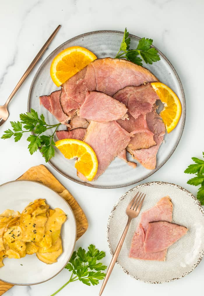 a plate of Instant Pot ham with oranges and parsley.