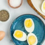 a blue plate with 3 hard-boiled egg halves.