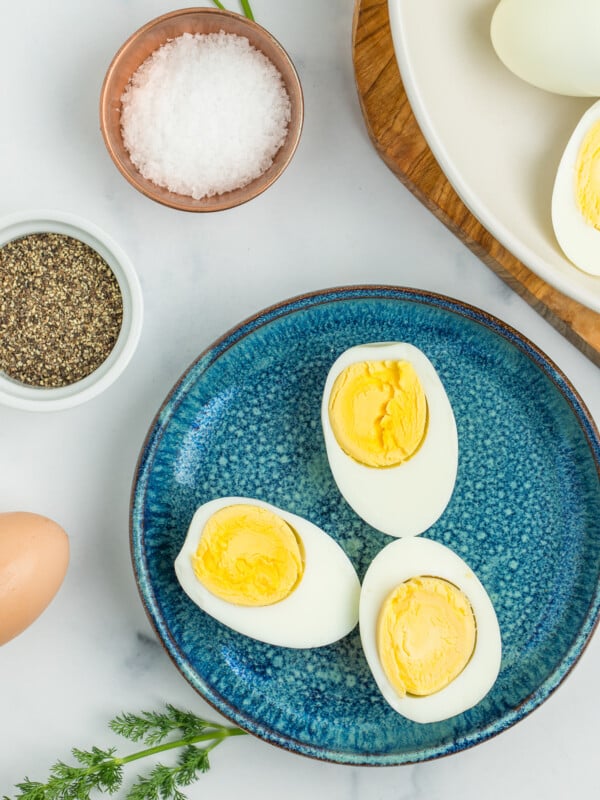 a blue plate with 3 hard-boiled egg halves.