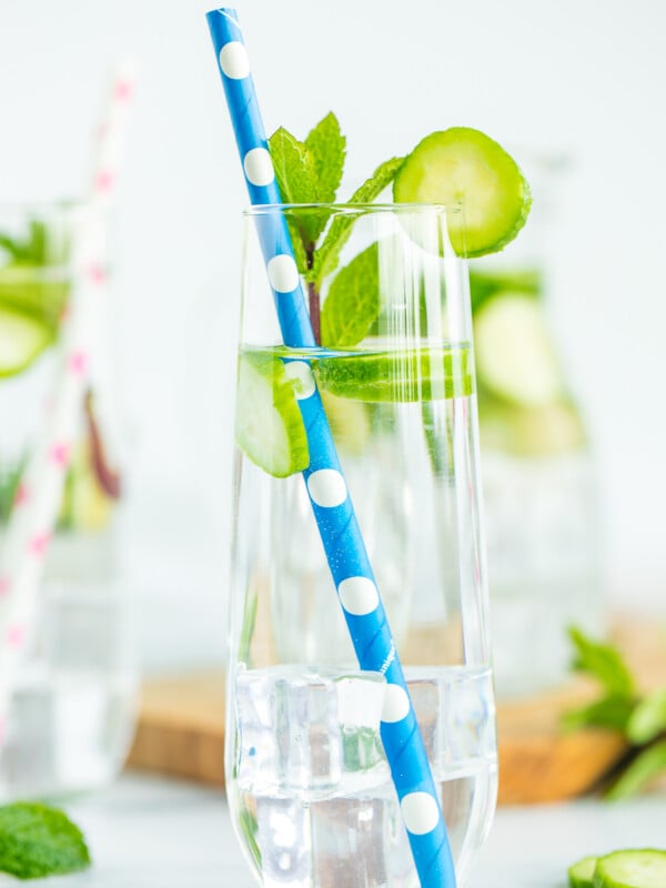 2 glasses and a pitcher full of cucumber mint water.