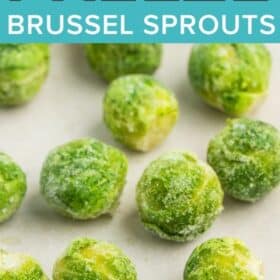 a tray with parchment covered in frozen brussel sprouts.