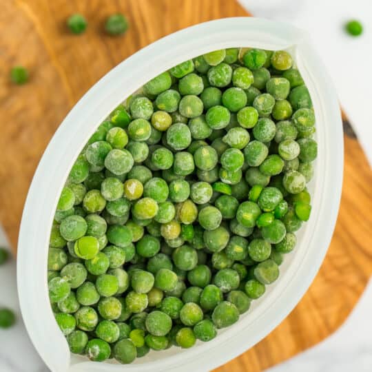 a silicone container of frozen peas.