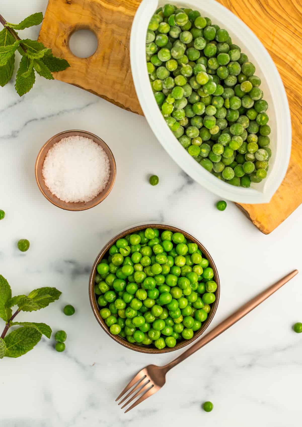 a small bowl of peas and a bag of frozen peas