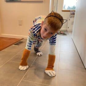 a kid in jammies with cat paw socks