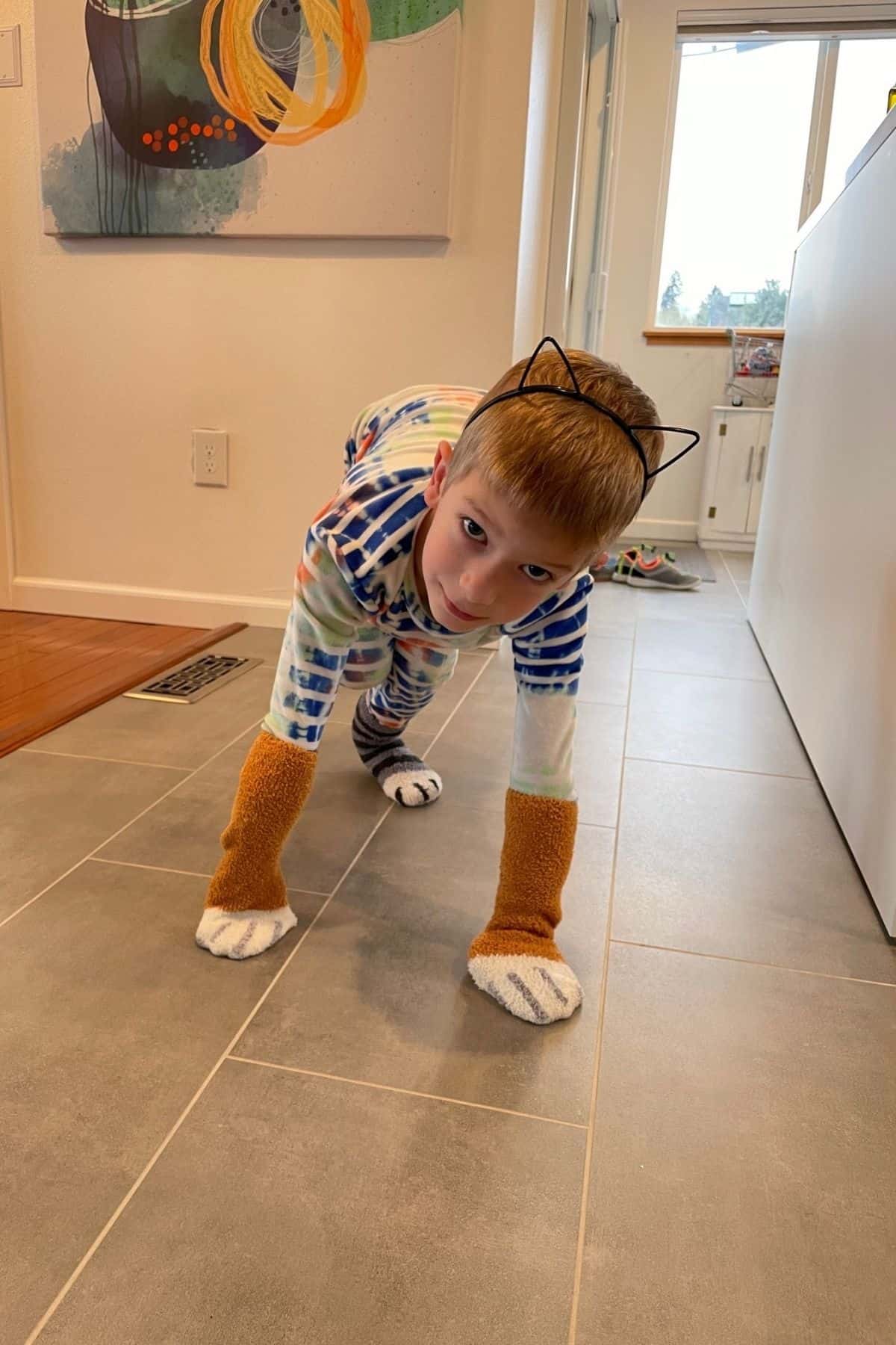 a kid in jammies with cat paw socks
