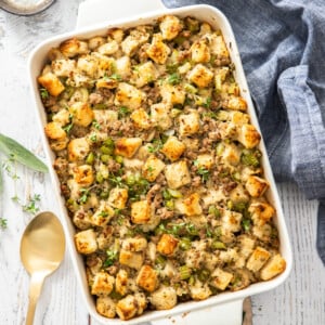 a white casserole dish with sausage dressing.