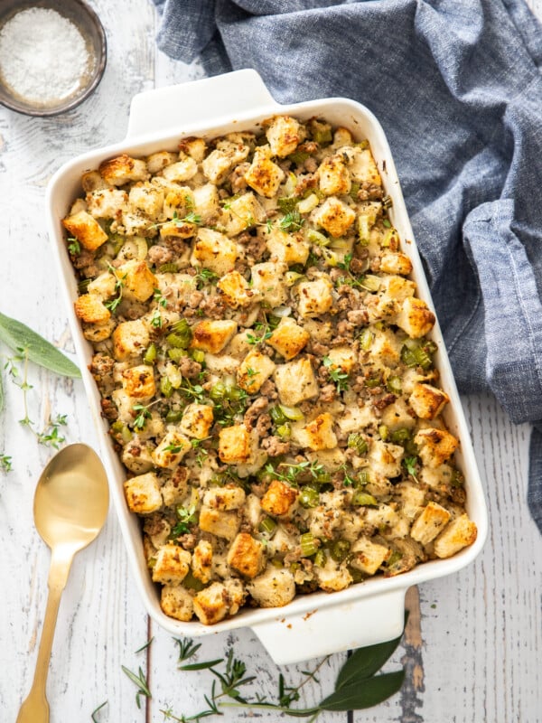 a white casserole dish with sausage dressing.