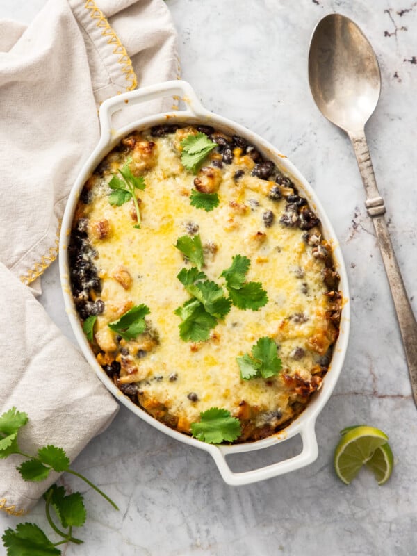 a turkey and rice casserole in a white baking dish topped with cilantro.