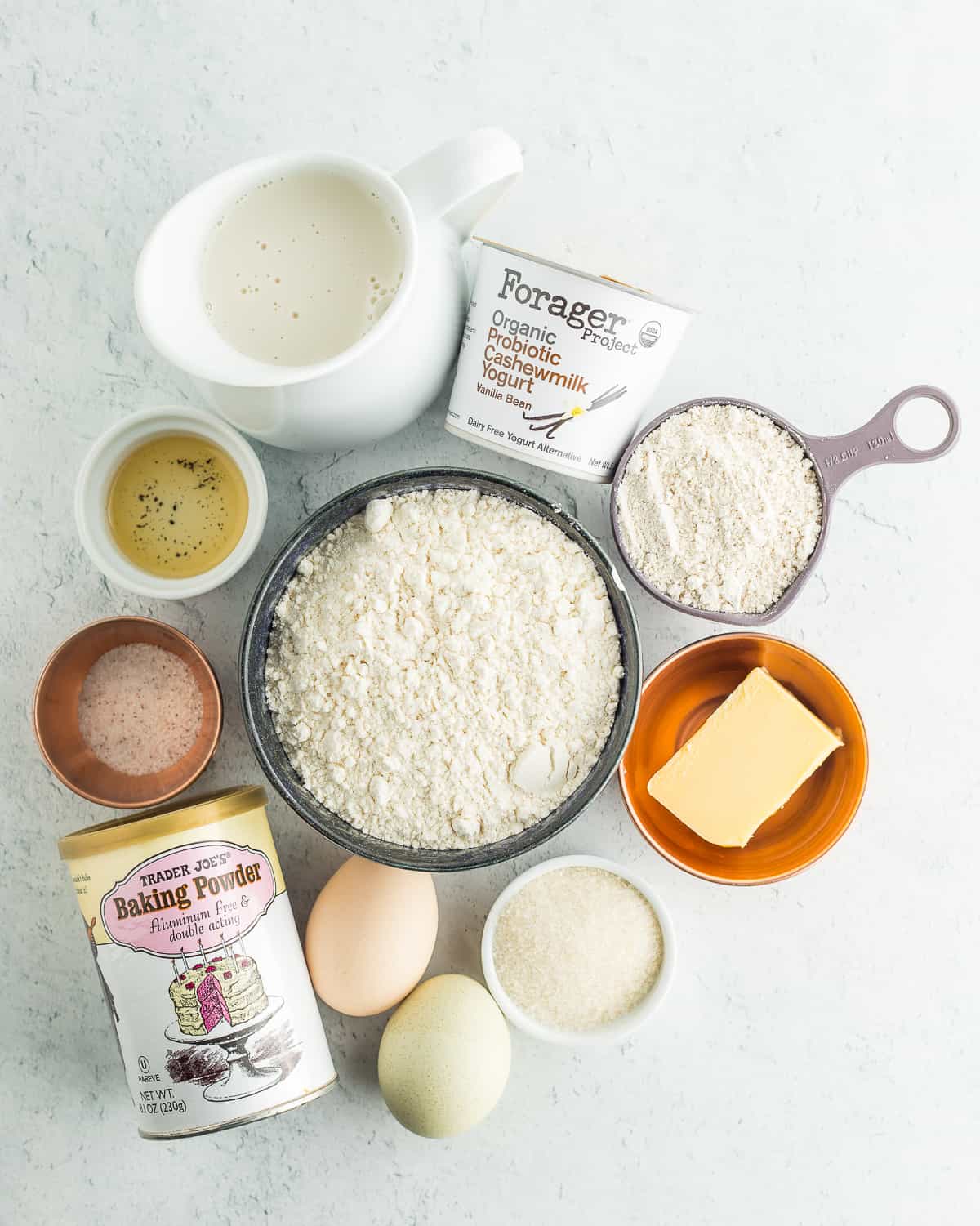 dairy-free yogurt, eggs, butter, flour, and other ingredients for making dairy-free pancakes