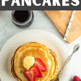 pancakes made with oatmilk on a white plate topped with butter and strawberries.