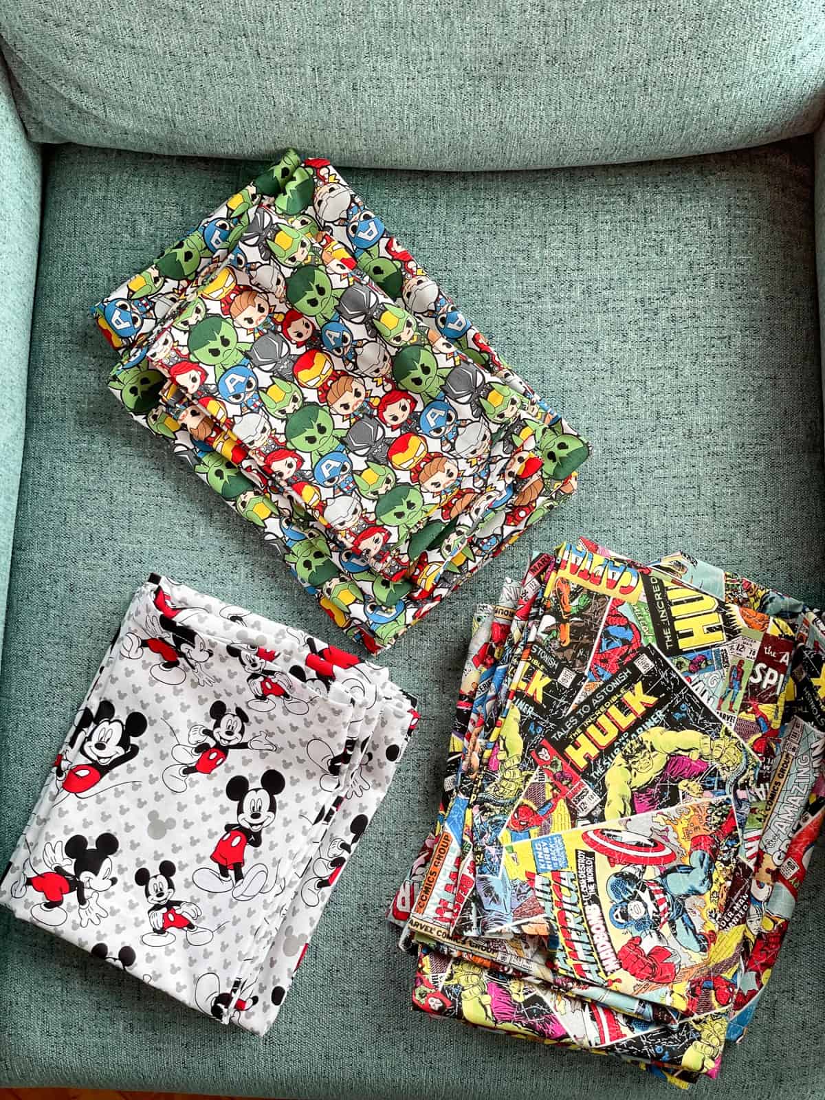 disney and marvel fabric on a teal chair.