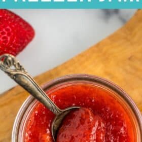 a jar of jam with a spoon in it.