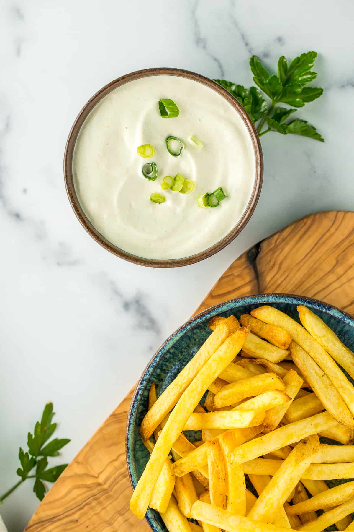 vegan mayonnaise dip in a bowl with a plate of french fries