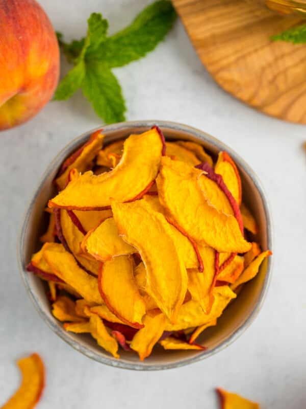 a grey bowl filled with dried peach slices.