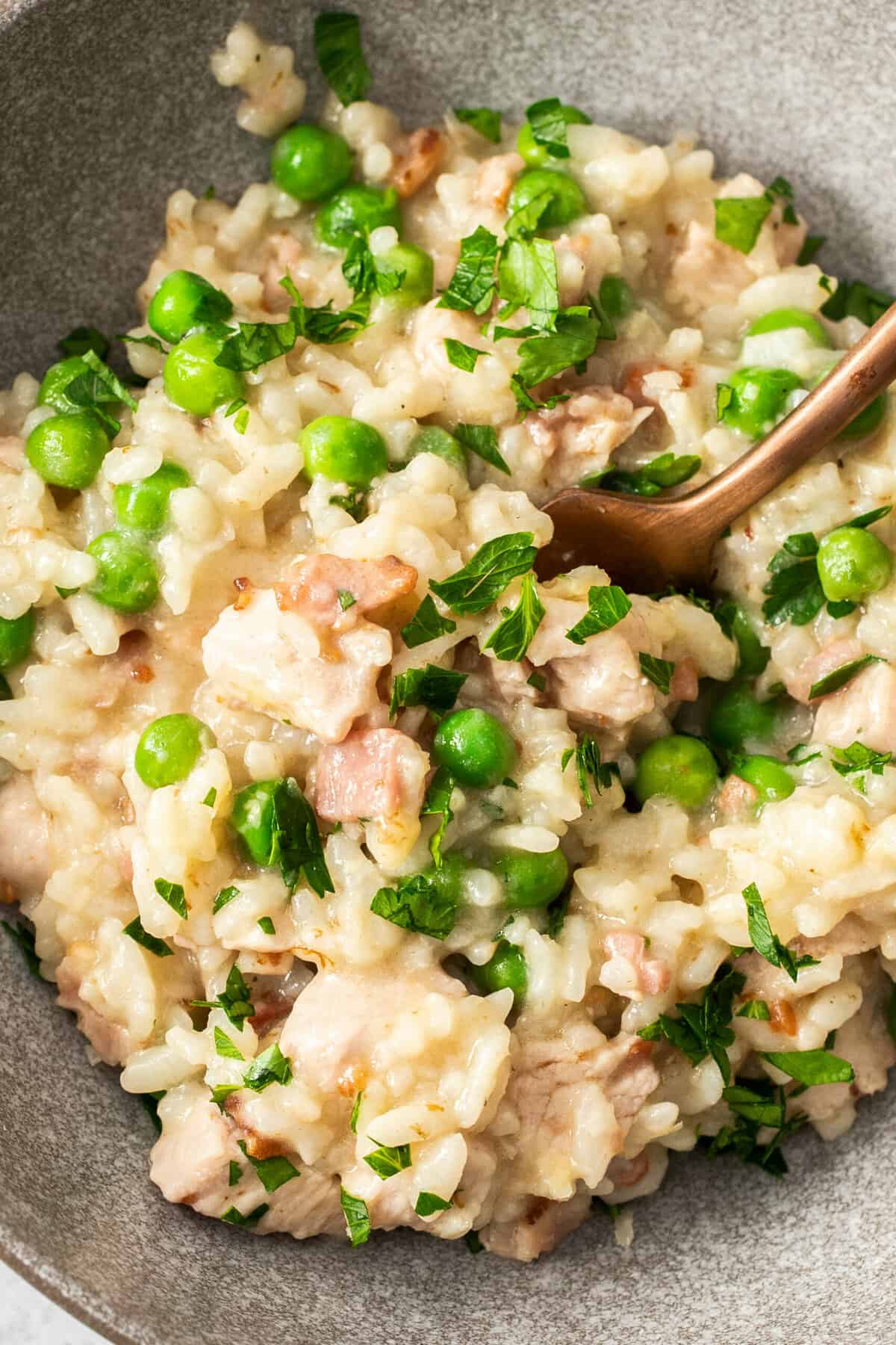 a creamy pea risotto topped with chopped parsley