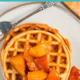 waffles on a plate topped with peach compote