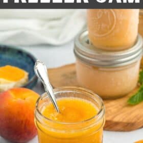 4 jars of peach freezer jam with fresh peaches and mint on a white board.