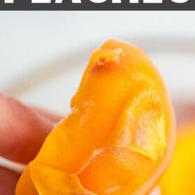 a hand holding a peach with the peel falling away.