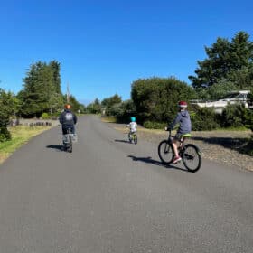 2 boys and their dad on bikes