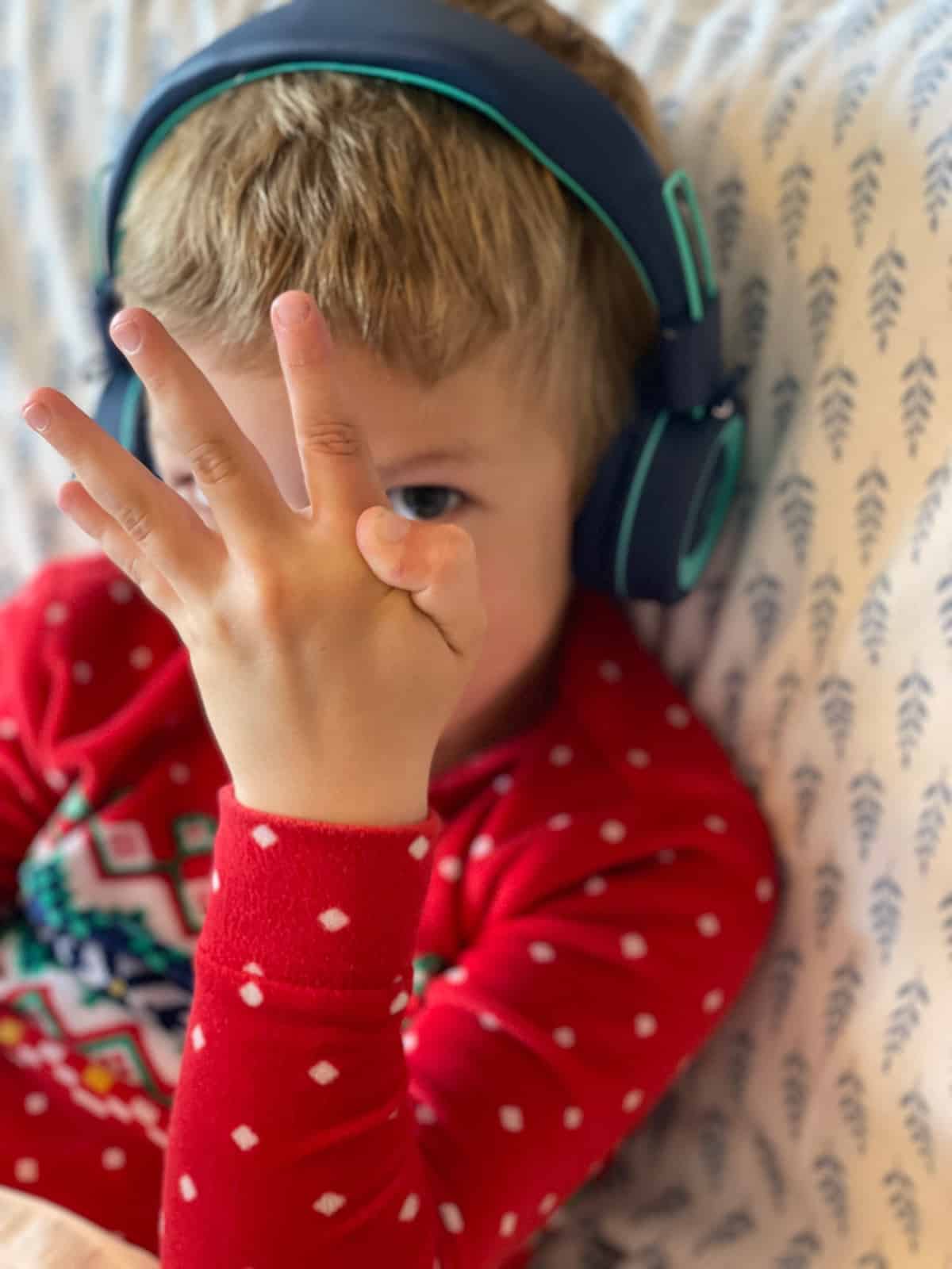 a kid in red pajamas with a weird finger.