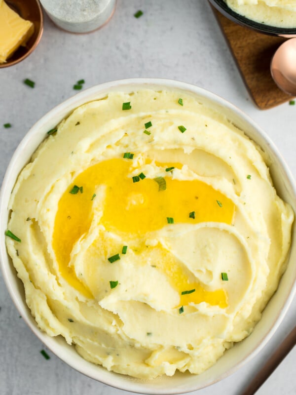 a bowl of Boursin mashed potatoes topped with butter and chives.