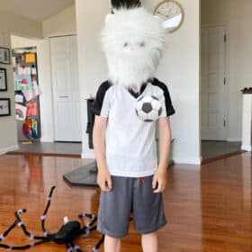 a kid wearing a cat head costume.