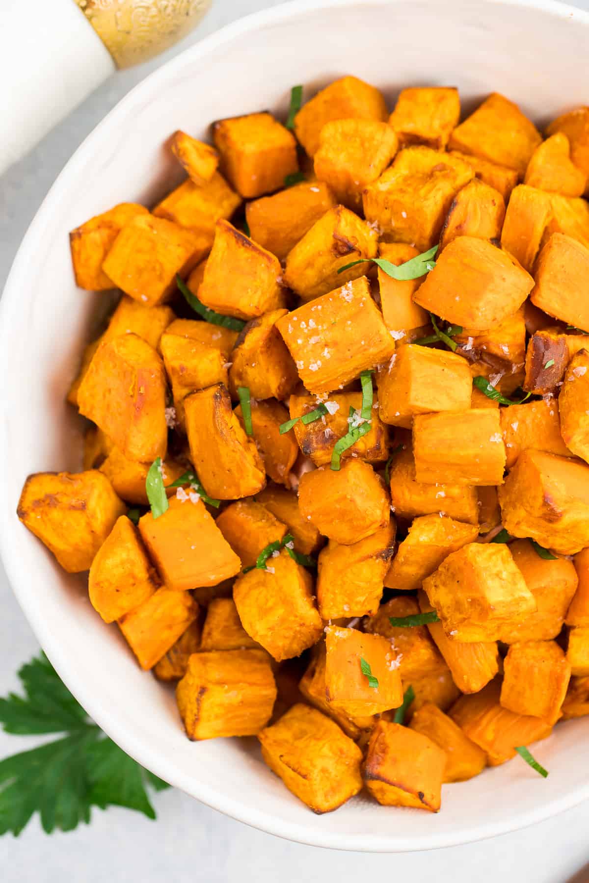 roasted cubed sweet potatoes in a white bowl.