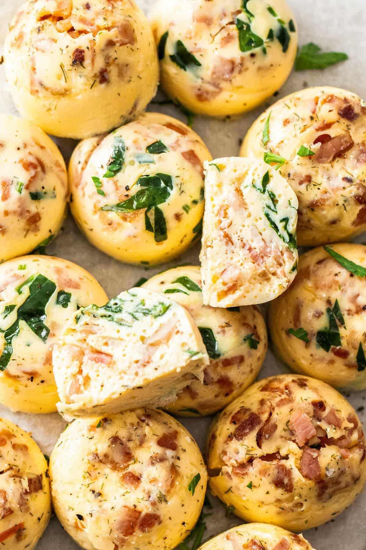 a tray of Instant Pot egg bites with spinach and chopped bacon..