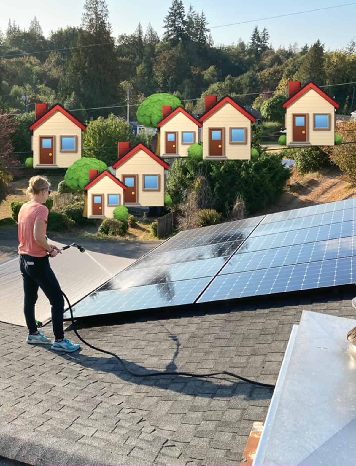 a woman on a roof with a hose cleaning solar panels.