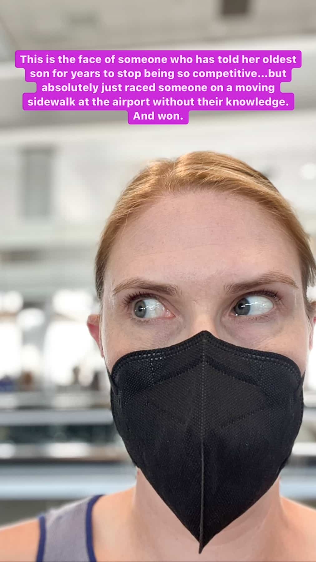 a woman in a mask at an airport.