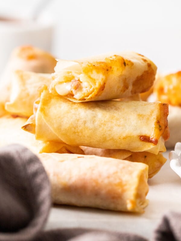 a stack of pizza egg rolls on a white board.