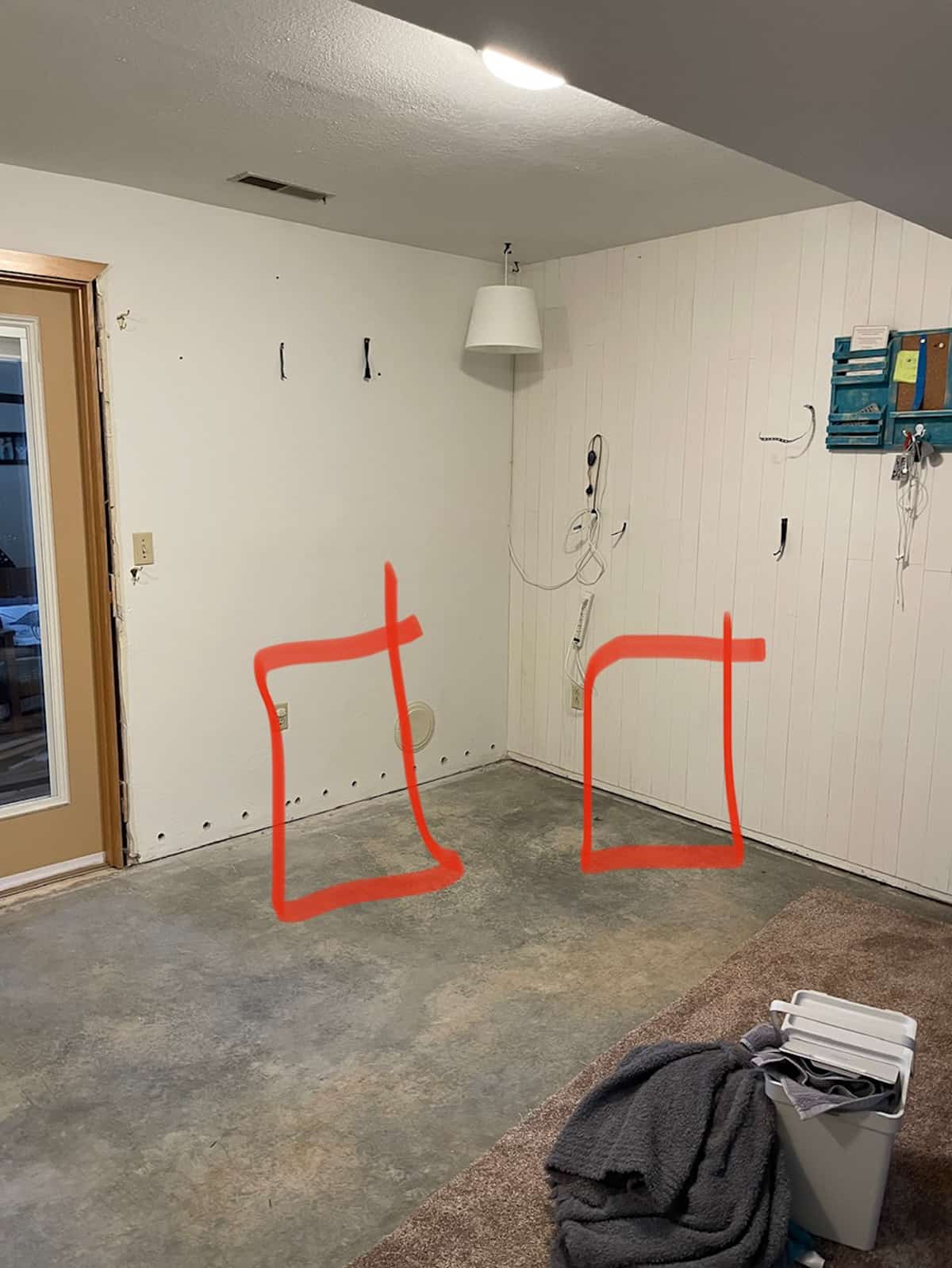 a corner of a basement with red lines drawn on it.