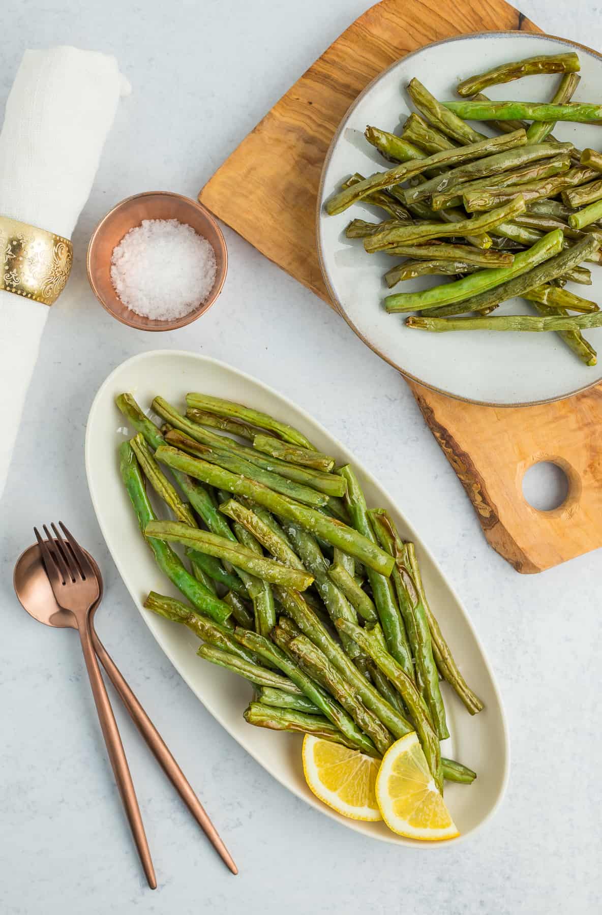 two plates of roasted green beans.