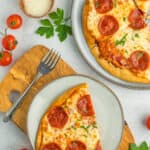 a grey plate with a tortilla pizza on a wooden board.